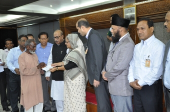 The Prime Minister handed over cheques of Tk 7 lakh to each Tazreen Fashions fire victim